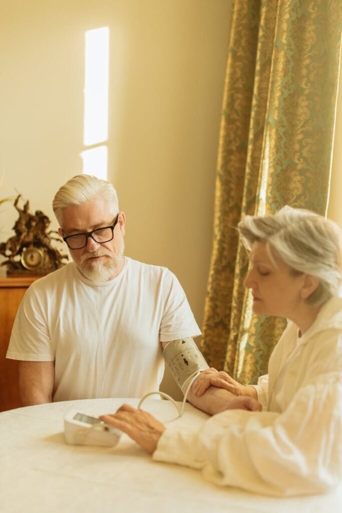 Adult Woman Checking the Man's Blood Pressure